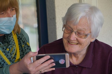 A person taking a picture of her phone