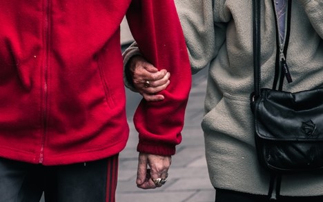 A close-up of two people holding hands