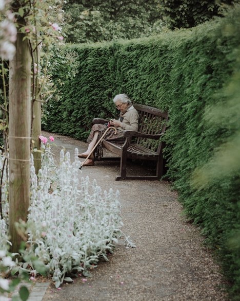 An old person sitting on a bench